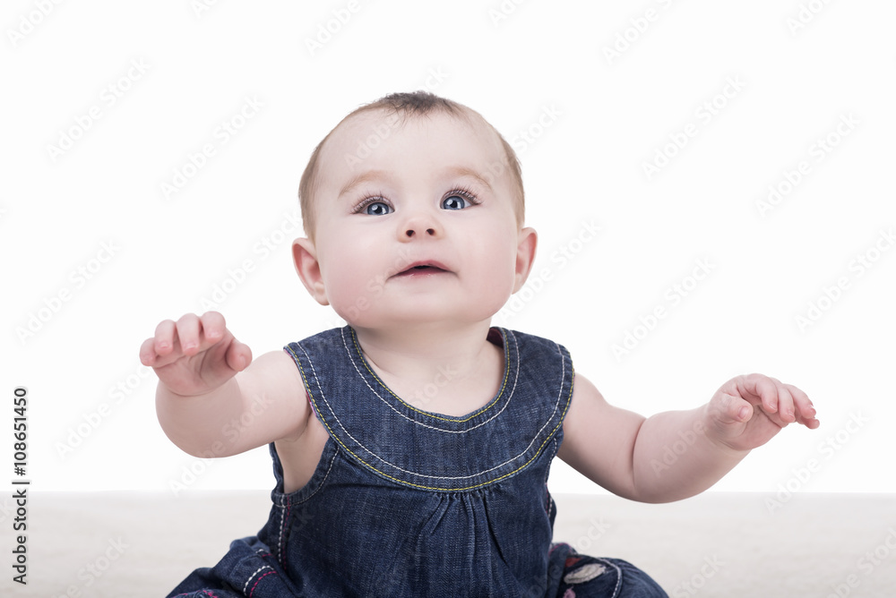 cute baby girl with blue eyes and long eyelashes. portrait of child, isolated. baby looking front into the camera cute baby girl with blue eyes and long eyelashes. portrait of child, isolated. baby looking front into the camera