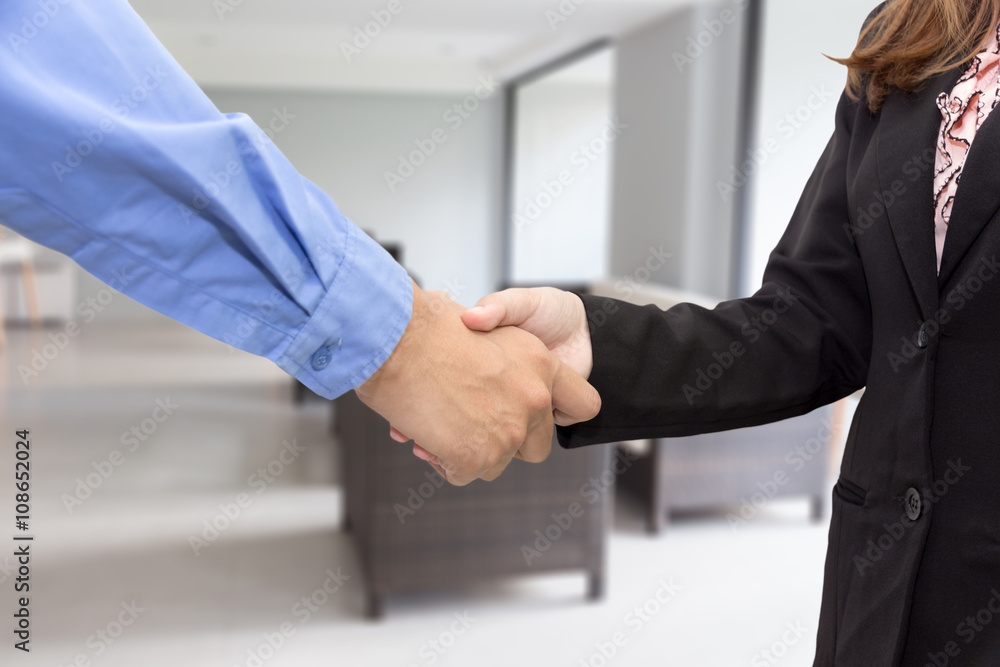 Businesswoman shaking hands in meeting room Businesswoman shaking hands in meeting room