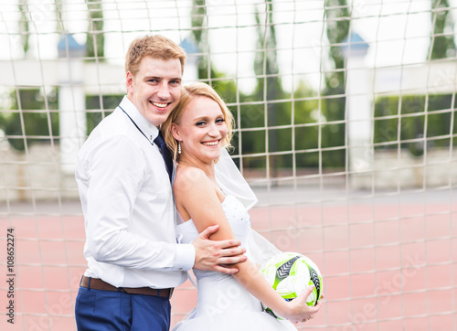 European Football Championship concept. Wedding couple on the football stadium.