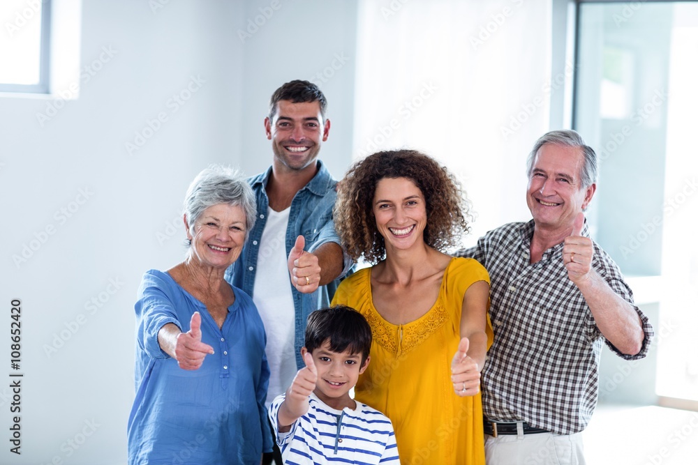 Portrait of happy family showing their thumbs up
