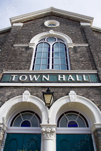 The facade of a traditional Town Hall building in England with a large 'TOWN HALL' sign across the front. photo