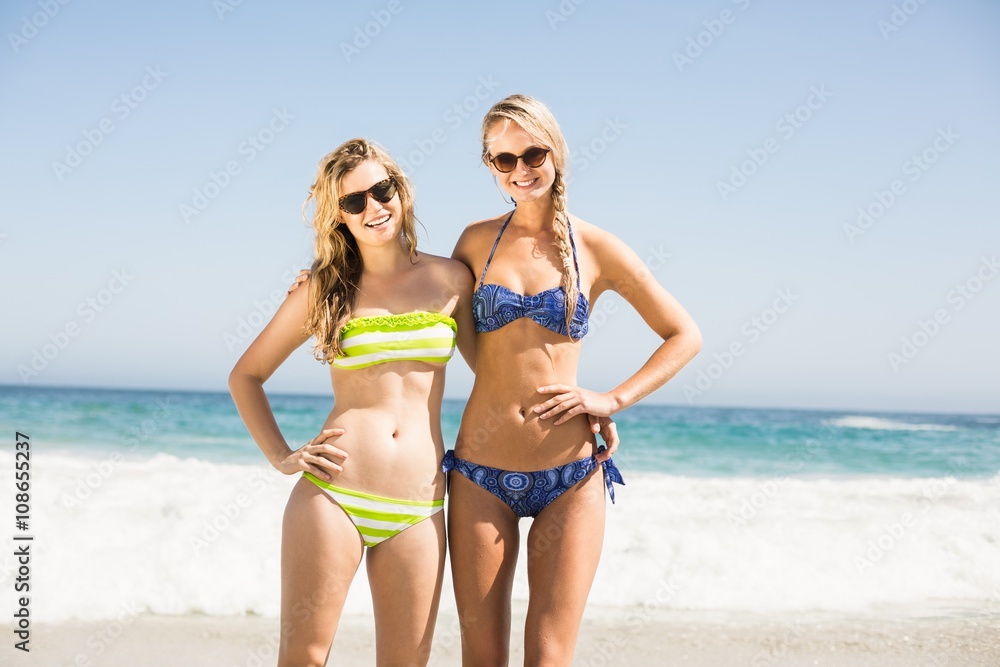 Portrait of two happy women standing on the beach Portrait of two happy women standing on the beach