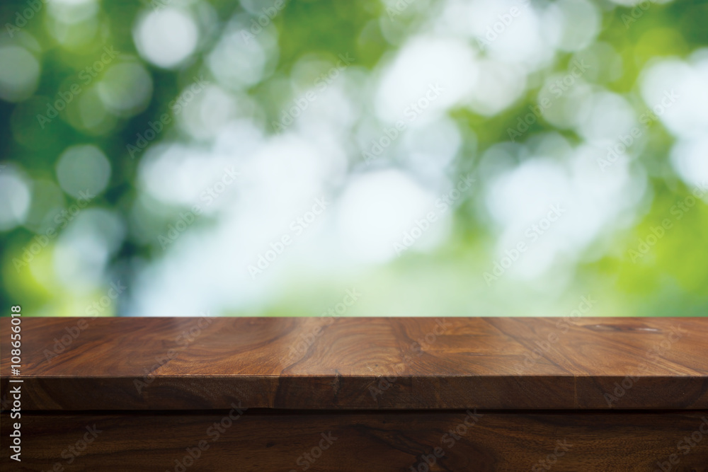 Empty top wooden table and floral blurred background Empty top wooden table and floral blurred background