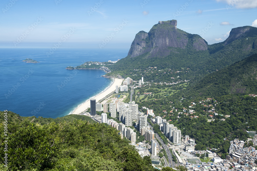 Scenic skyline view from above Sao Conrado Beach with Pedra da Gavea mountain and the favela community of Rocinha