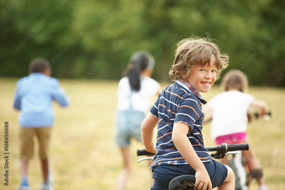 Fototapeta premium Kids with mountainbike and scooter