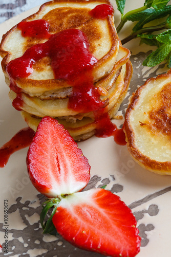 Freshly baked pancakes with strawberry and mint