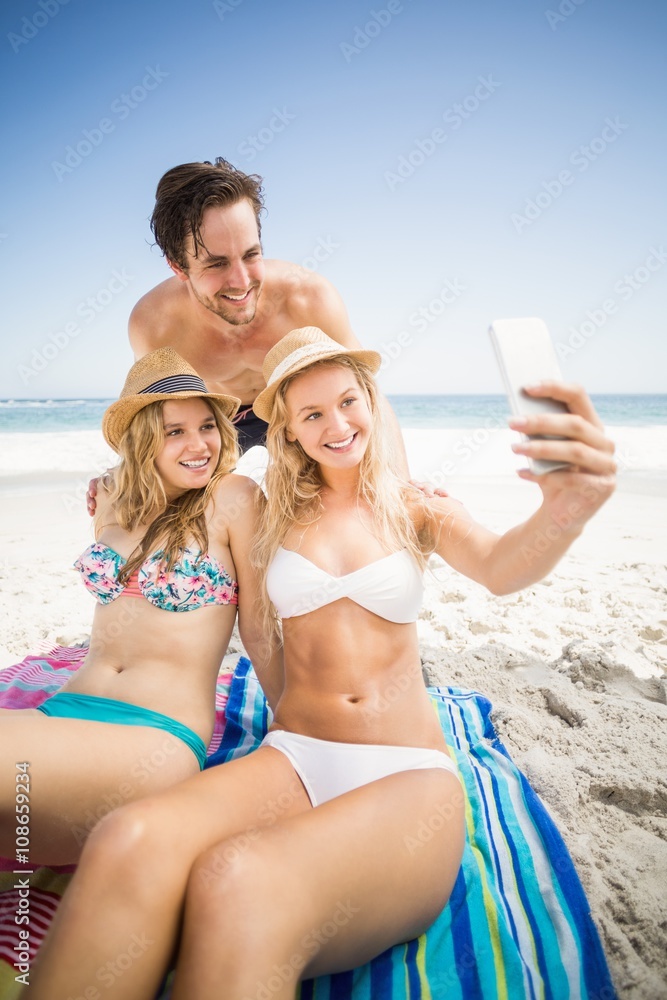 Young friends taking a selfie on the beach