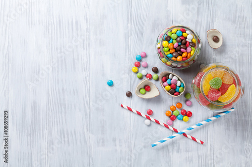 Colorful candies on wooden table