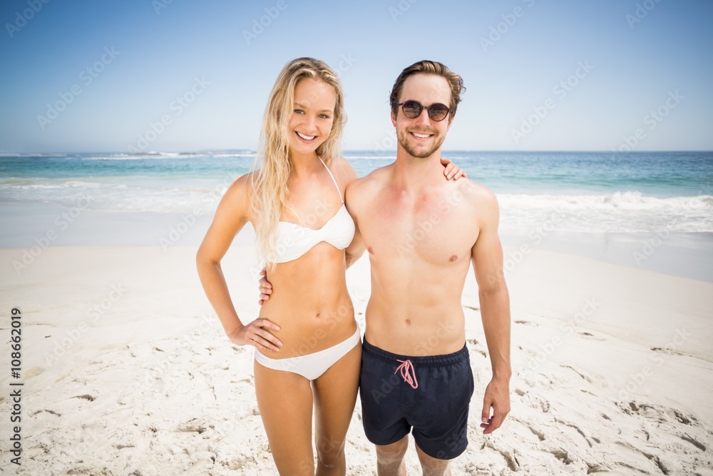 Portrait of young couple standing on the beach