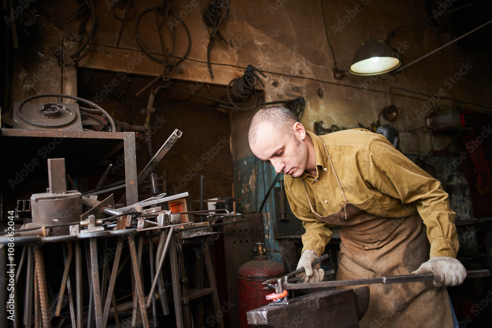 The wizard removes the excess weld using a power saw with a metal layout of a construction crane The wizard removes the excess weld using a power saw with a metal layout of a construction crane