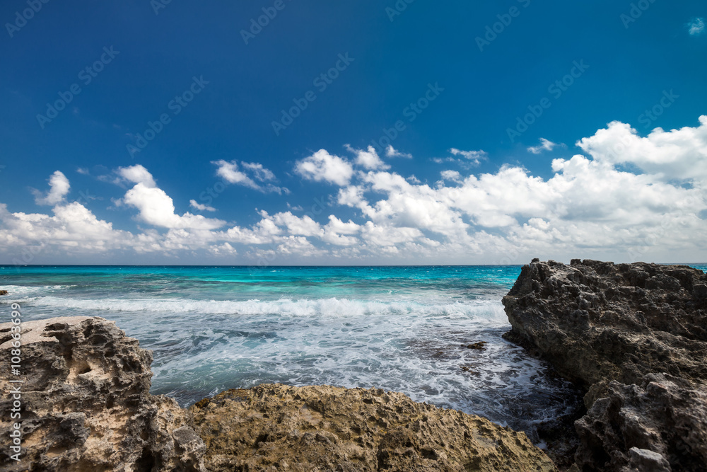 Ocean with waves and rocks on beach