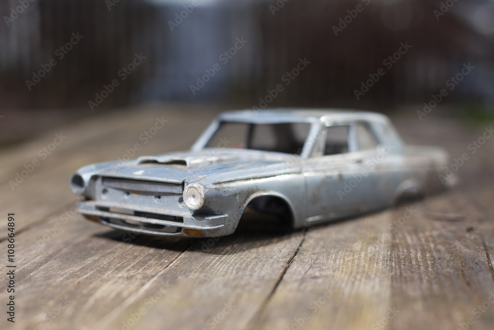 Broken model of american car on wood table. small depth of focus. selective focus.