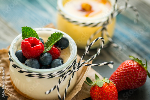 Jar with fresh yogurt on a rustic table