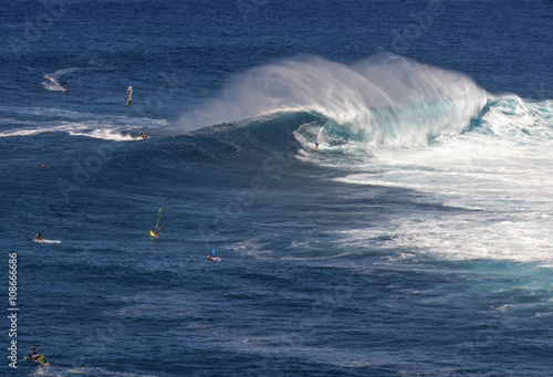 Surfer on wave at Peahi or Jaws surf break, Maui, Hawaii, USA