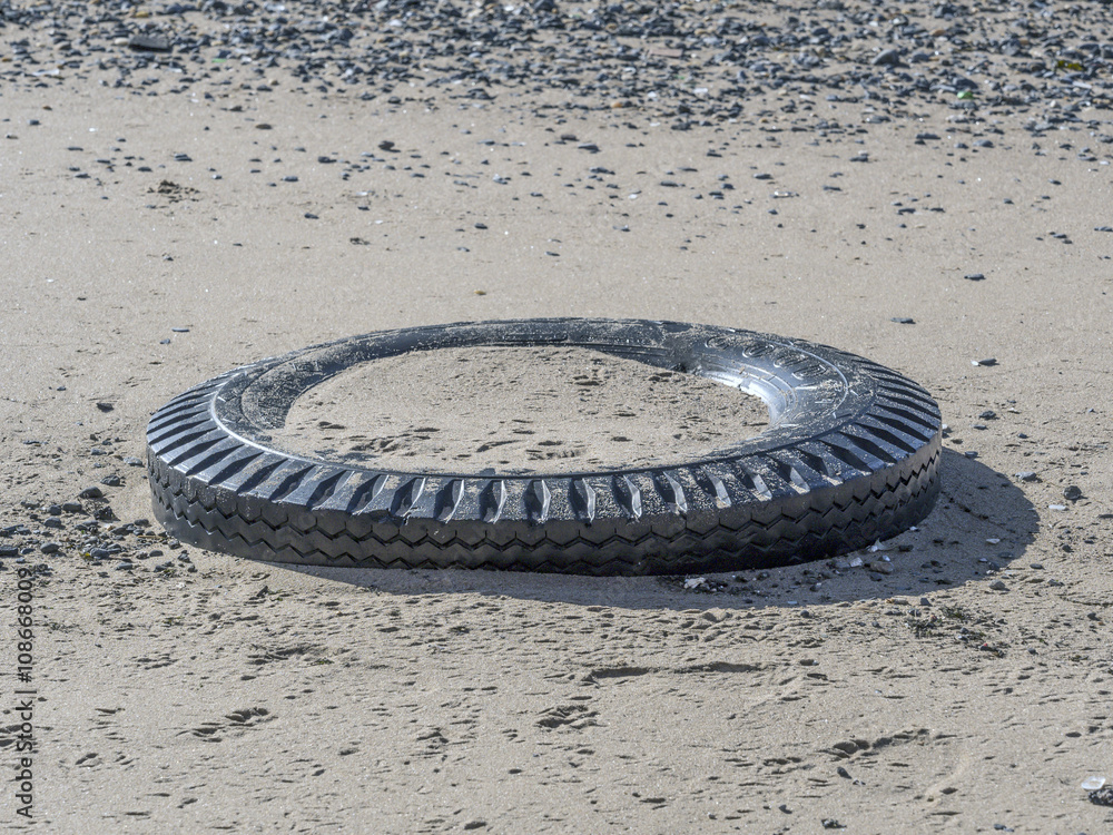 old tire on beach old tire on beach