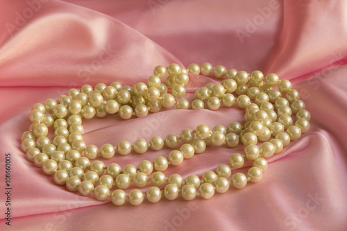 Pearl Necklace on delicate Pink silk background