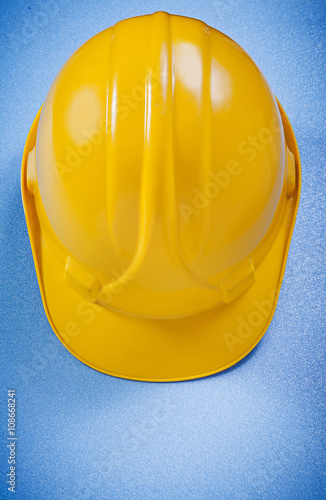 Safety helmet on blue background construction concept