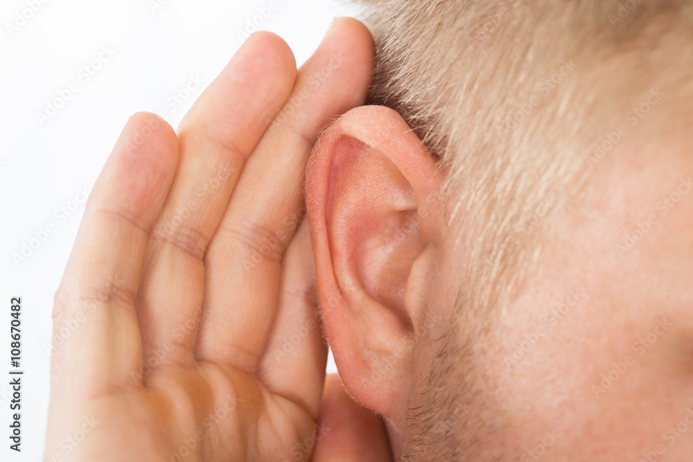 Person Trying To Hear With Hand Over Ear Person Trying To Hear With Hand Over Ear