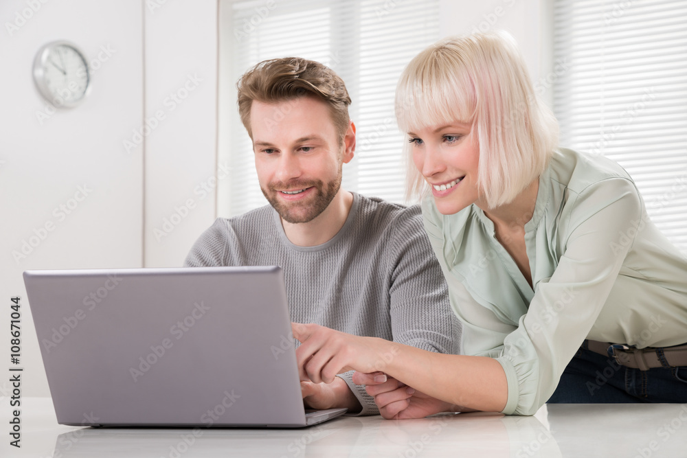 Young Couple Using Laptop Young Couple Using Laptop
