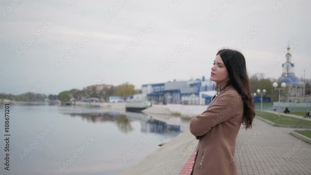 Girl on the waterfront looks into the distance Girl on the waterfront looks into the distance