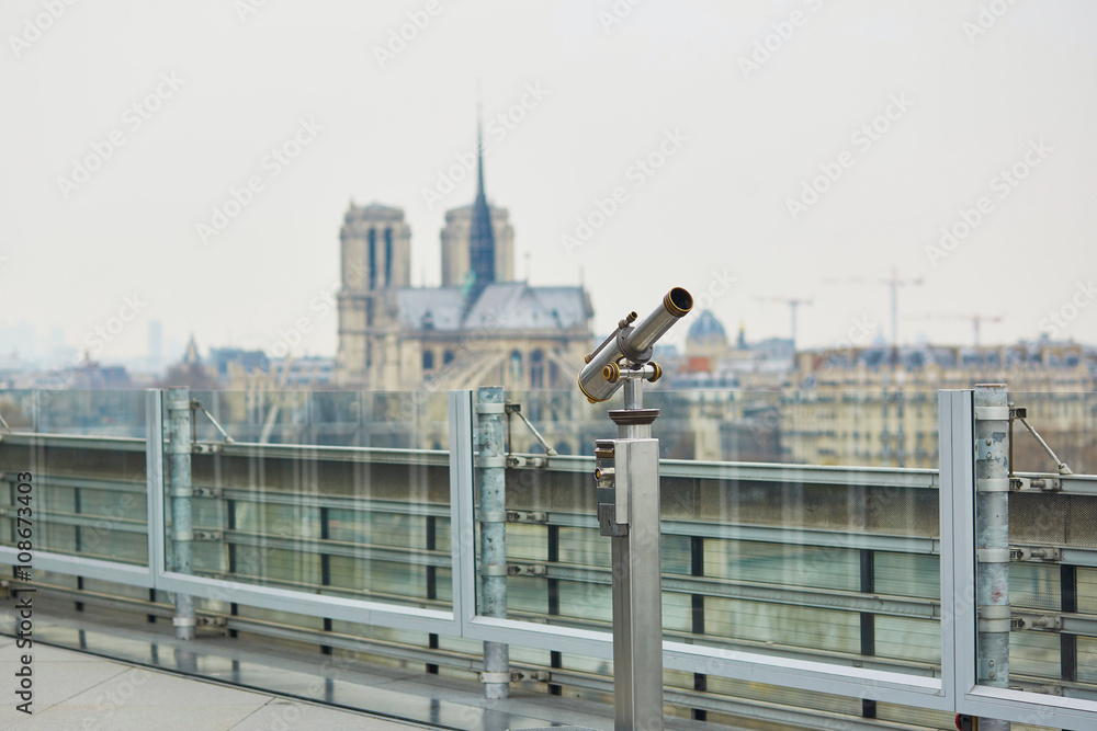 Fototapeta premium Touristic telescope with view on the Notre Dame in Paris, France