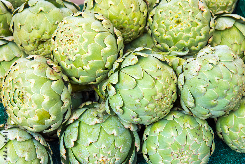 Fototapeta premium Green artichokes for sale at a market