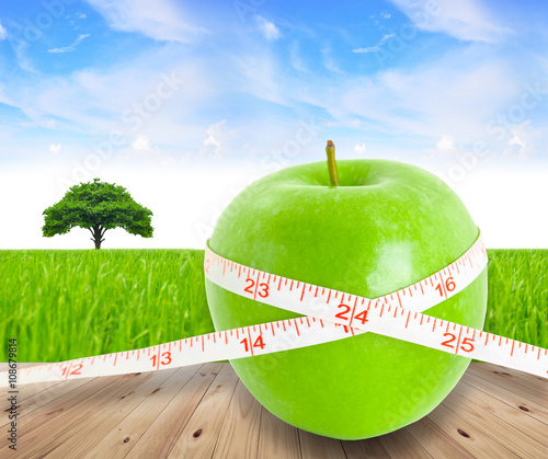 Green apple fruit with a Measure. photo