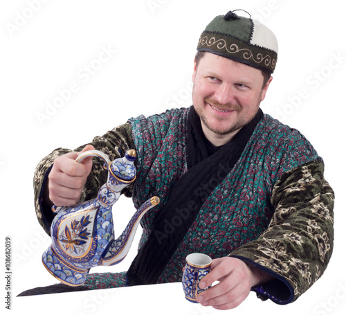 Man in traditional oriental robe with ornamental bow photo