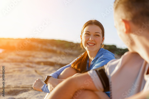 Couple in sport wear on beach