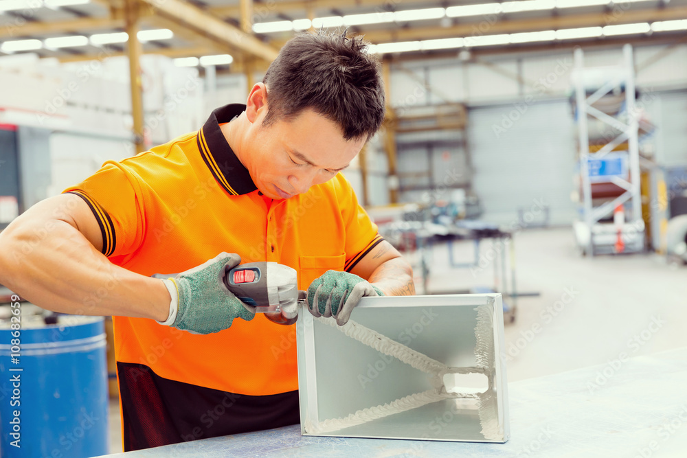 Asian worker in production plant on the factory floor Asian worker in production plant on the factory floor