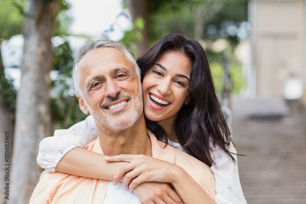 Woman embracing man from behind