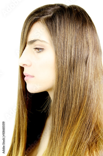 Portrait of profile of beautiful woman with straight soft silky hair in front of eye