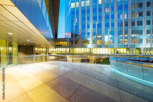 empty marble floor and modern buildings at night