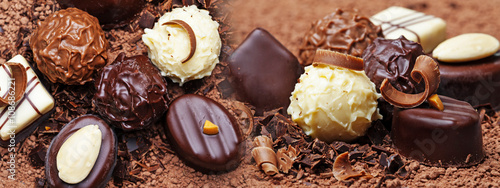 a chocolate background with pralines