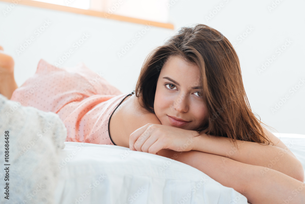 Fototapeta premium Relaxed woman lying in bed