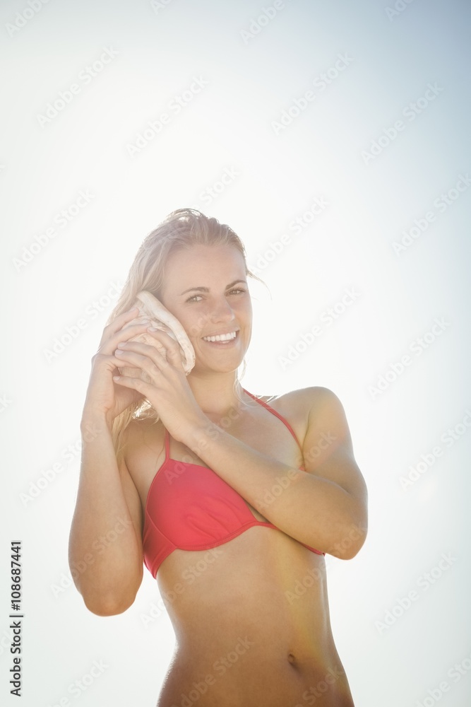 Woman listening into a seashell