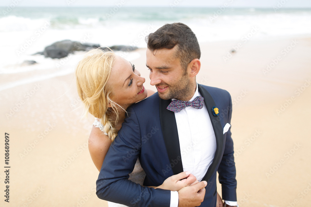 bride and groom posing on the beach bride and groom posing on the beach