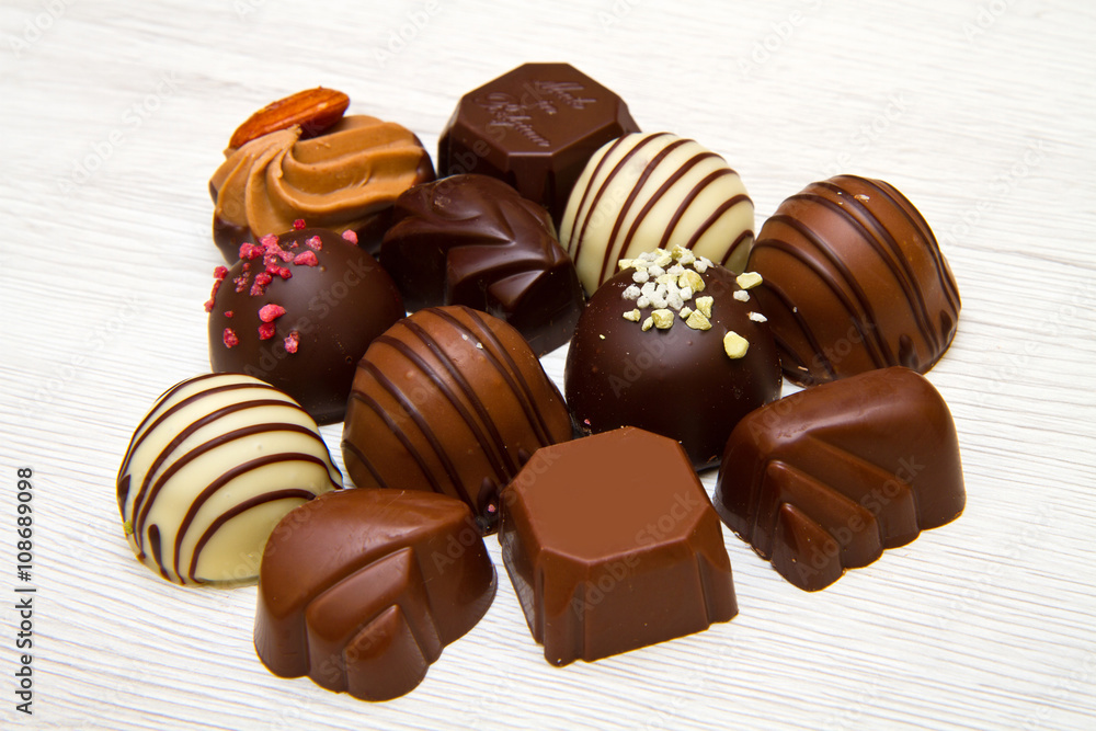 An assortment of fine chocolates in white, dark, and milk chocol An assortment of fine chocolates in white, dark, and milk chocol