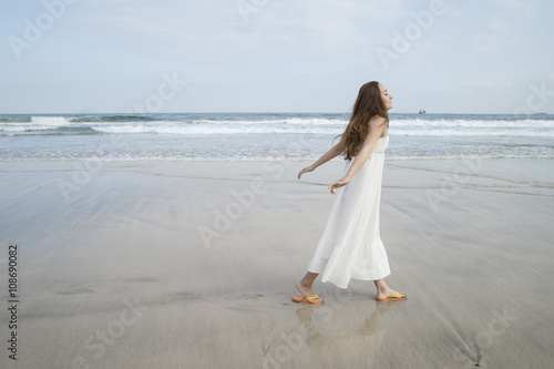 Young women are taking a walk along the beach © Monet