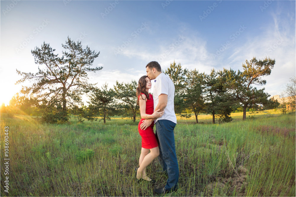 Happy young couple embrace in park