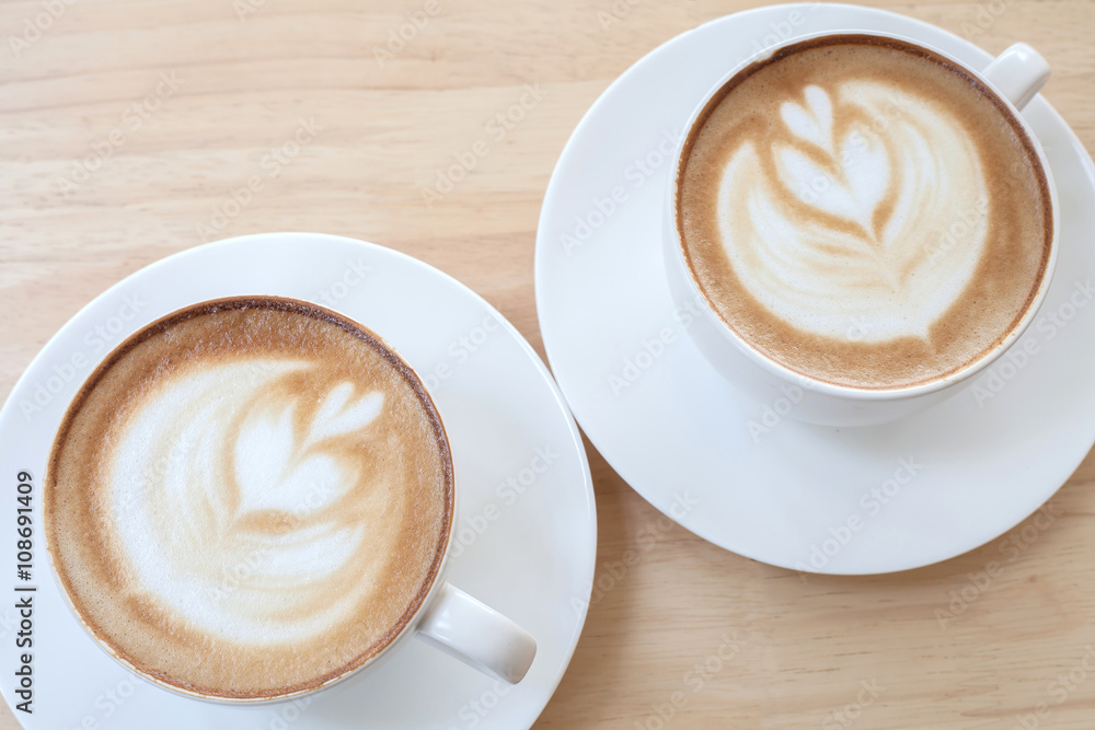 Hot art Latte Coffee in a cup on wooden table Hot art Latte Coffee in a cup on wooden table