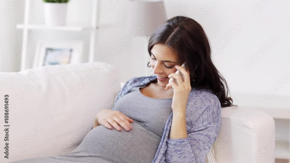 happy pregnant woman calling on smartphone at home happy pregnant woman calling on smartphone at home