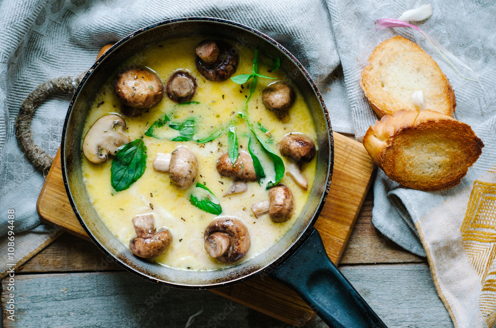 Melting mozzarella in pan with mushrooms, basil and garlic croutons Melting mozzarella in pan with mushrooms, basil and garlic croutons