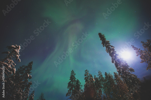 Beautiful picture of massive multicoloured green vibrant Aurora Borealis  Aurora Polaris  also know as Northern Lights in the night sky over winter Lapland landscape  Norway  Scandinavia