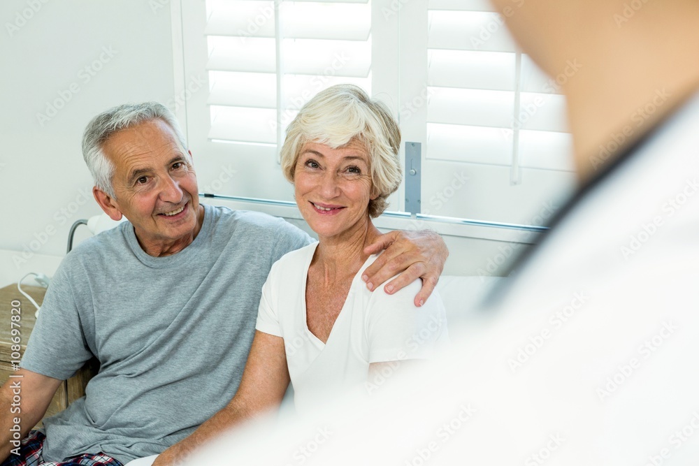 Smiling senior couple with doctor at home Smiling senior couple with doctor at home