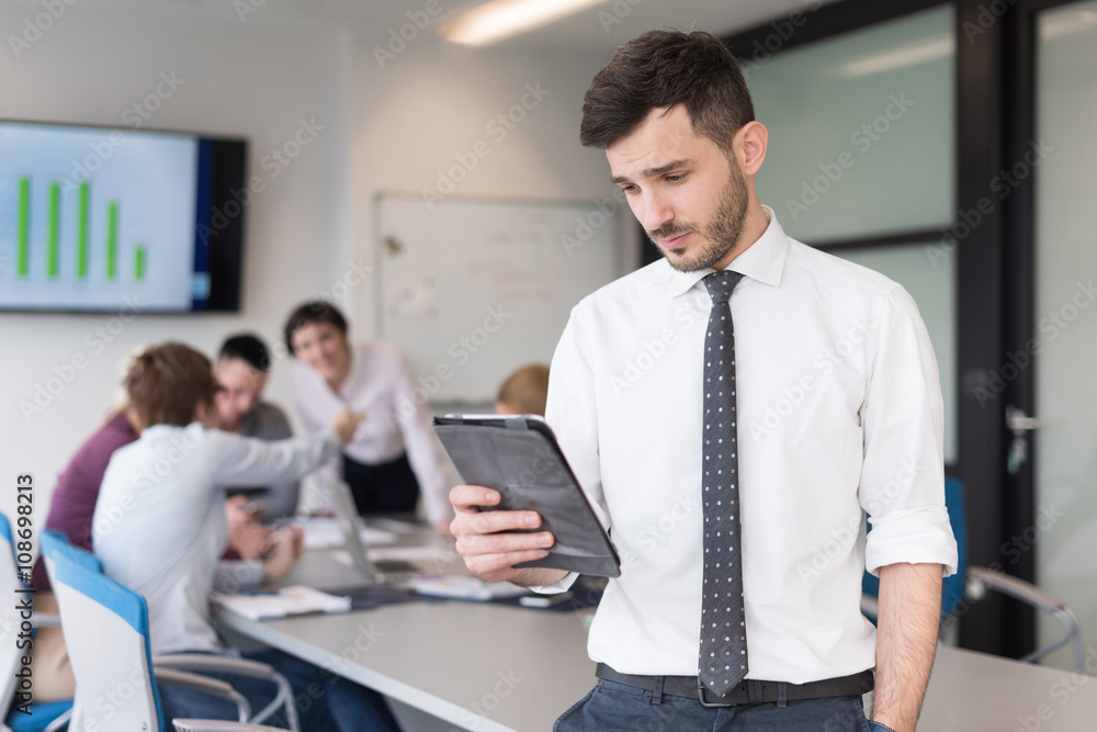 young business man with tablet at office meeting room young business man with tablet at office meeting room