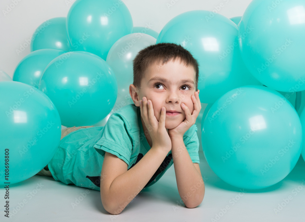 young man lying on the floor, around him are balloons young man lying on the floor, around him are balloons
