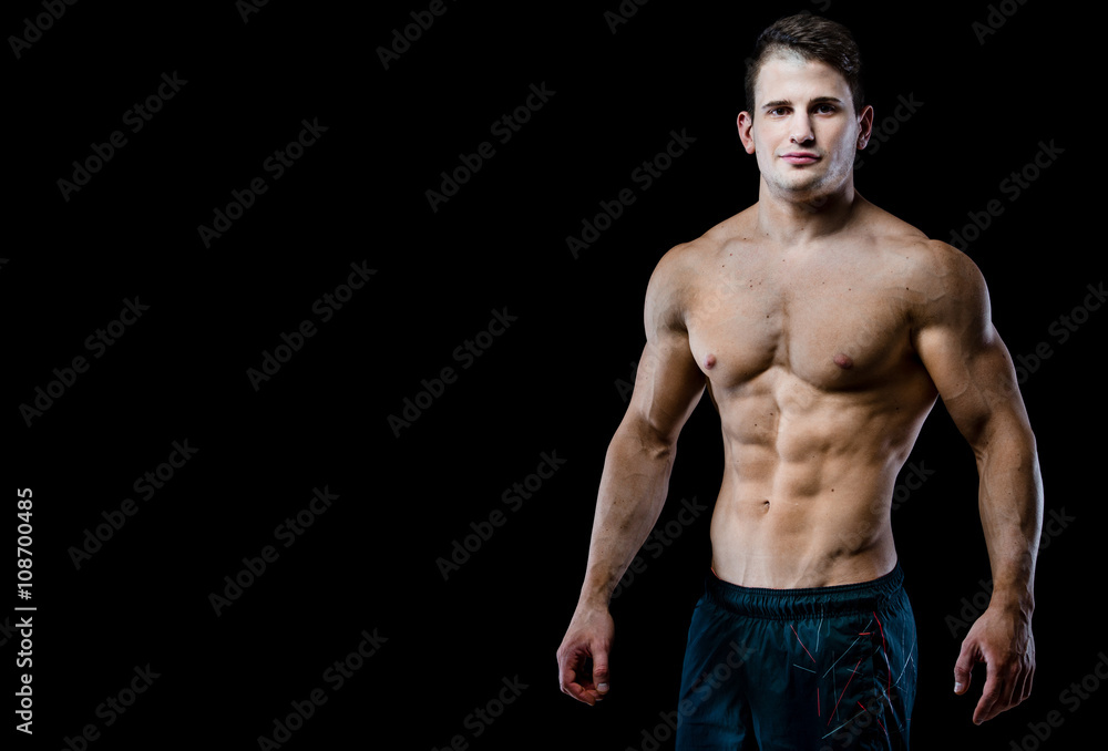 Young and fit male model posing his muscles