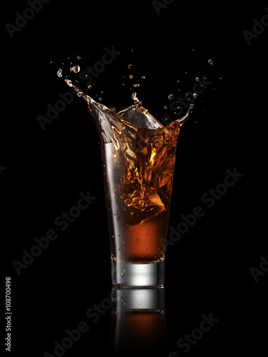 Splash in alcoholic drink on black background