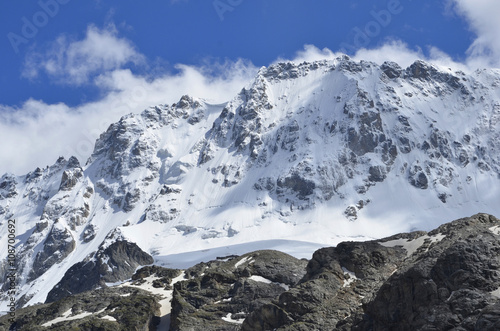 Gently the scattered clouds floated due to the snowy mountain